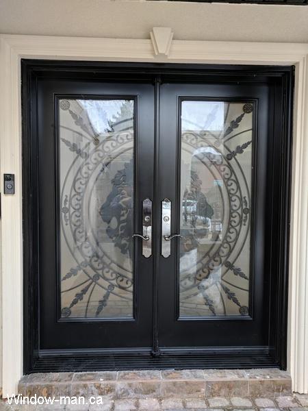 Exterior doors. Double front entry steel insulated. Black. Full wrought iron glass inserts. Forest King Lions iron glass design